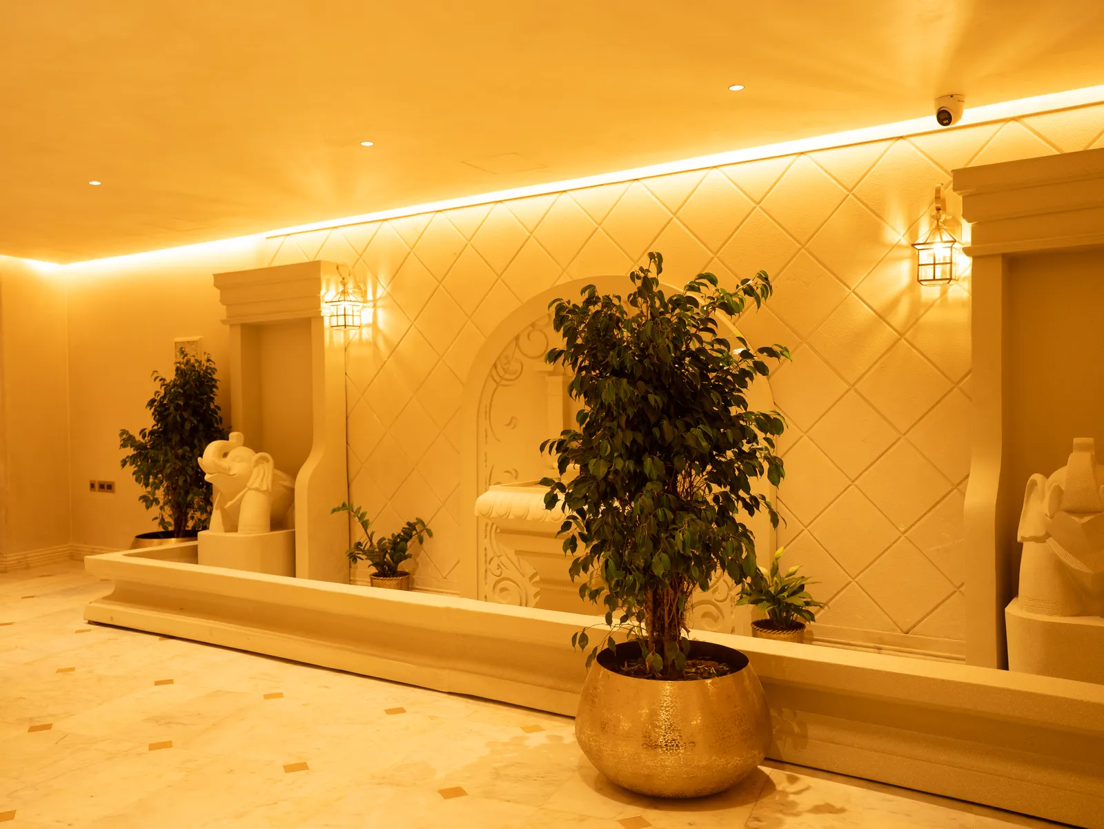 Lobby with carved arch fountain wall and planters — Chalukya Samrat